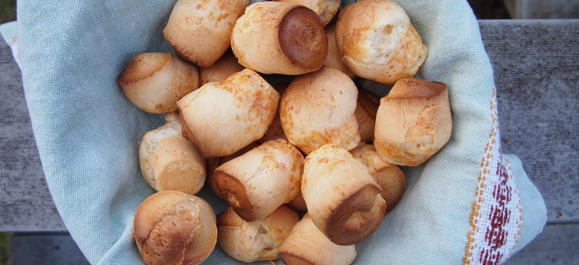 Freshly baked Brazilian cheese bread in a cloth-lined basket